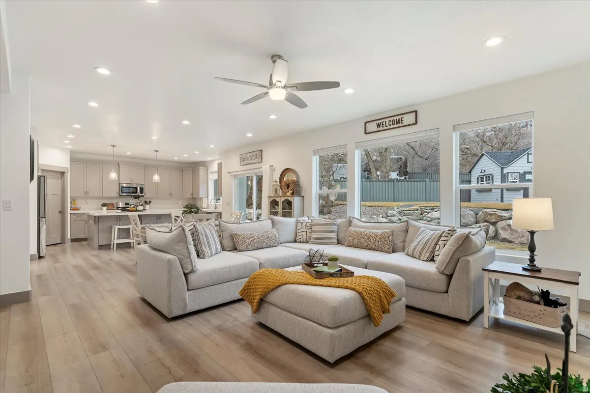Open-concept living area featuring light wood-finish flooring and recessed lighting throughout