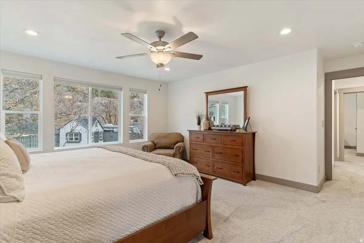 Spacious room with multiple windows, recessed lighting, and a ceiling fan
