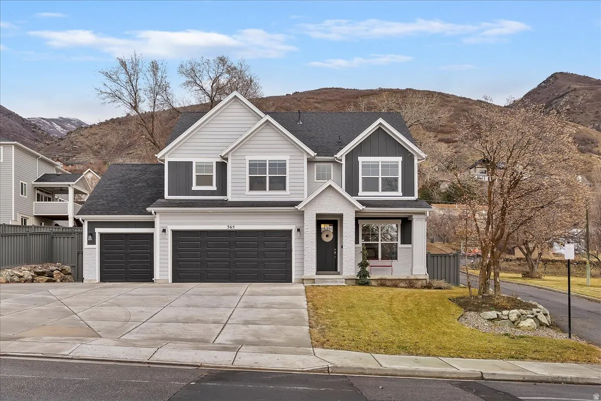 Modern two-story residence with a two-tone facade and a prominent three-car garage