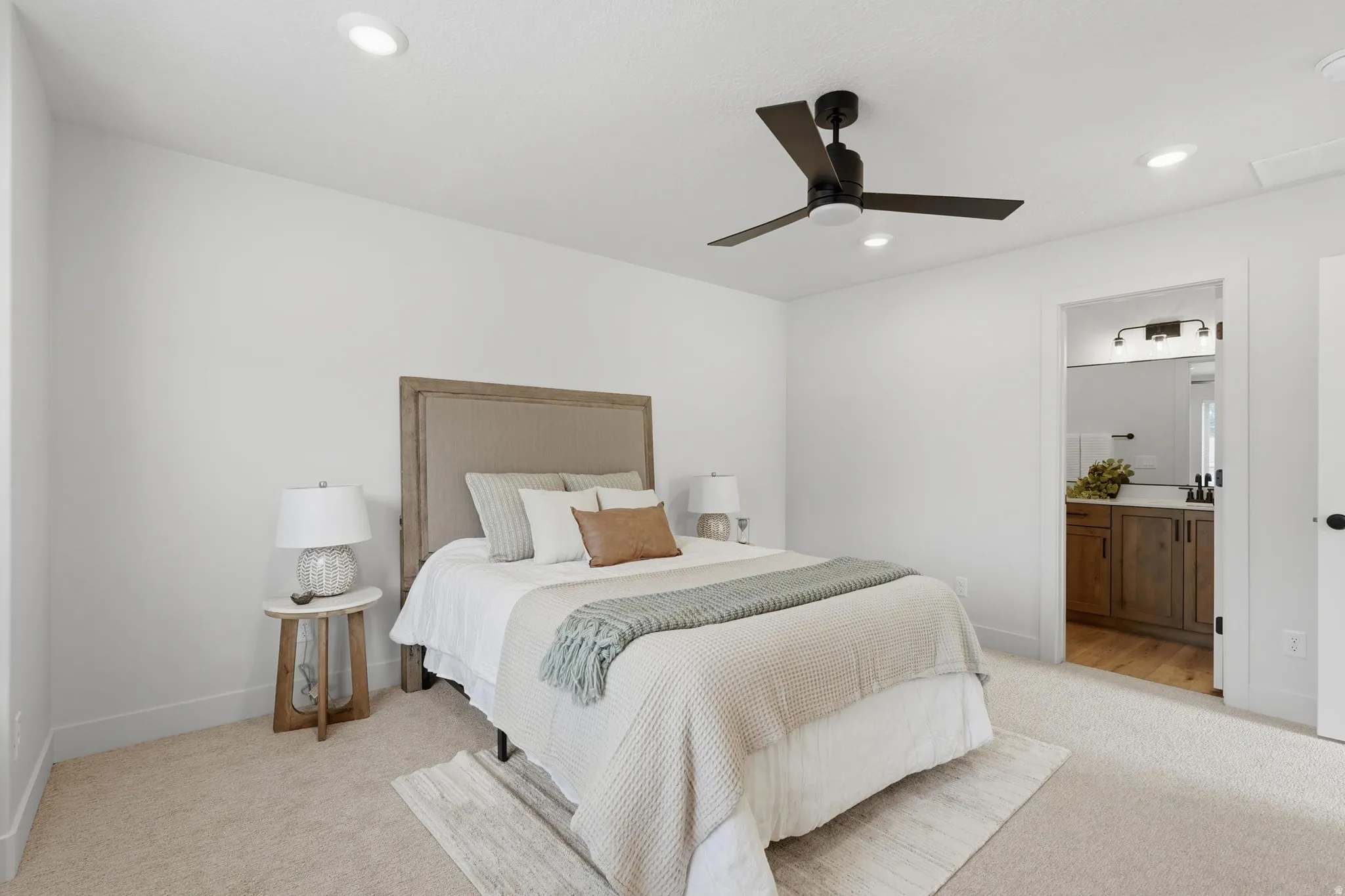 Bedroom with neutral carpet flooring and white walls