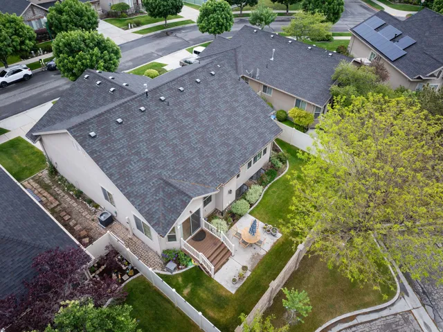 Rear exterior featuring a multi-level deck, a concrete patio, and a manicured lawn
