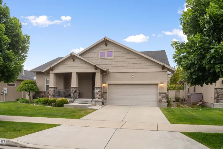 Single-story residence featuring a two-car garage with a concrete driveway
