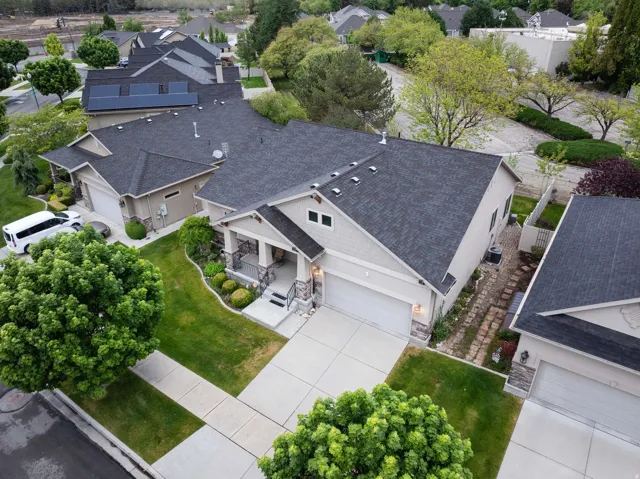 Contemporary home exterior featuring a dark asphalt shingle roof, solar panels, and a two-car garage