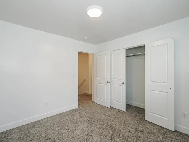 Neutral white walls with textured ceiling and a flush-mount overhead light