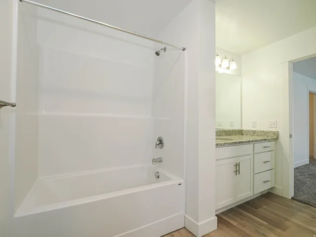 Bathroom featuring a white tub and shower combination with a chrome faucet