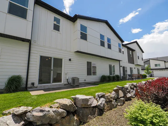 Contemporary multi-level exterior with white horizontal siding and dark trim accents