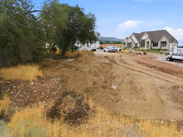 Graded lot featuring natural vegetation and a partially cleared area