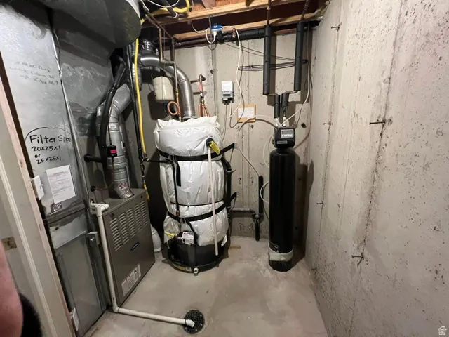Utility area featuring a newer furnace and water heater, and water softener system