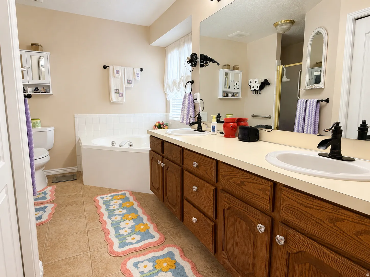 Primary bathroom with separate jetted tub/shower and dual vanity.