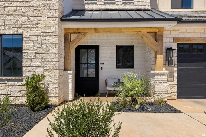 Stone veneer facade with a covered entry