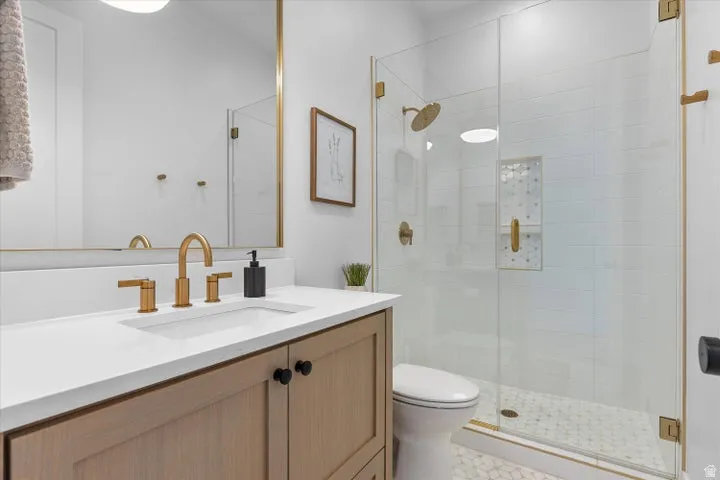 Contemporary bathroom featuring a light wood-finish vanity with a white countertop and integrated sink