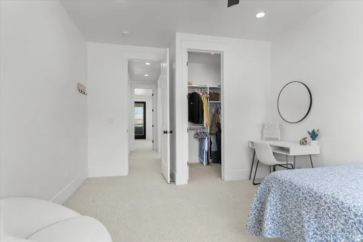 Neutral-toned carpeting and bright white walls create a clean aesthetic
