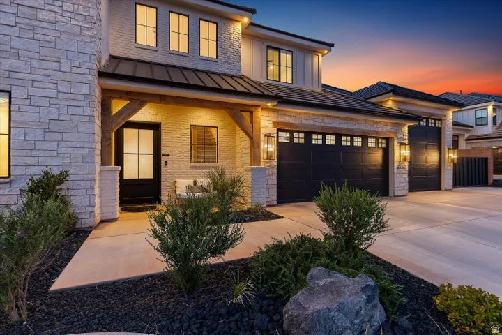 Contemporary exterior featuring light-colored stone and horizontal siding accents