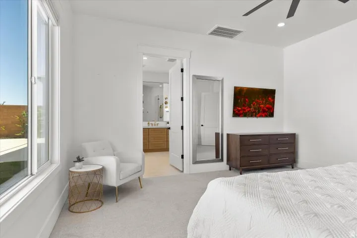 Carpeted room featuring a large window, recessed lighting, and a ceiling fan