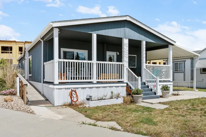 Siding exterior with a covered porch and white railings