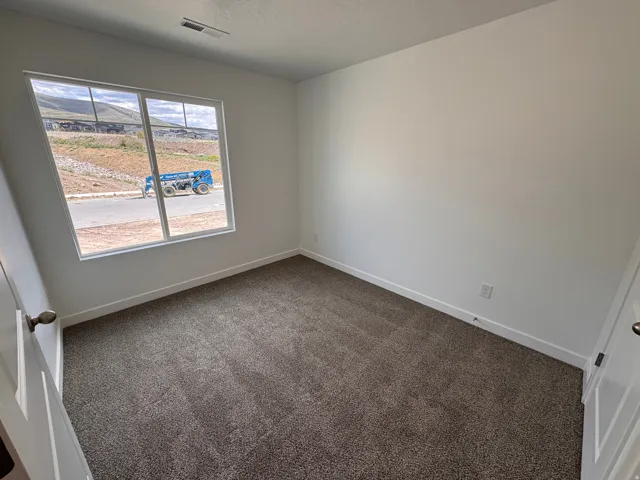 Room featuring neutral-toned carpeting and white walls