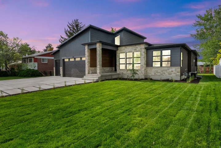 Modern exterior with stone accents and dark horizontal siding