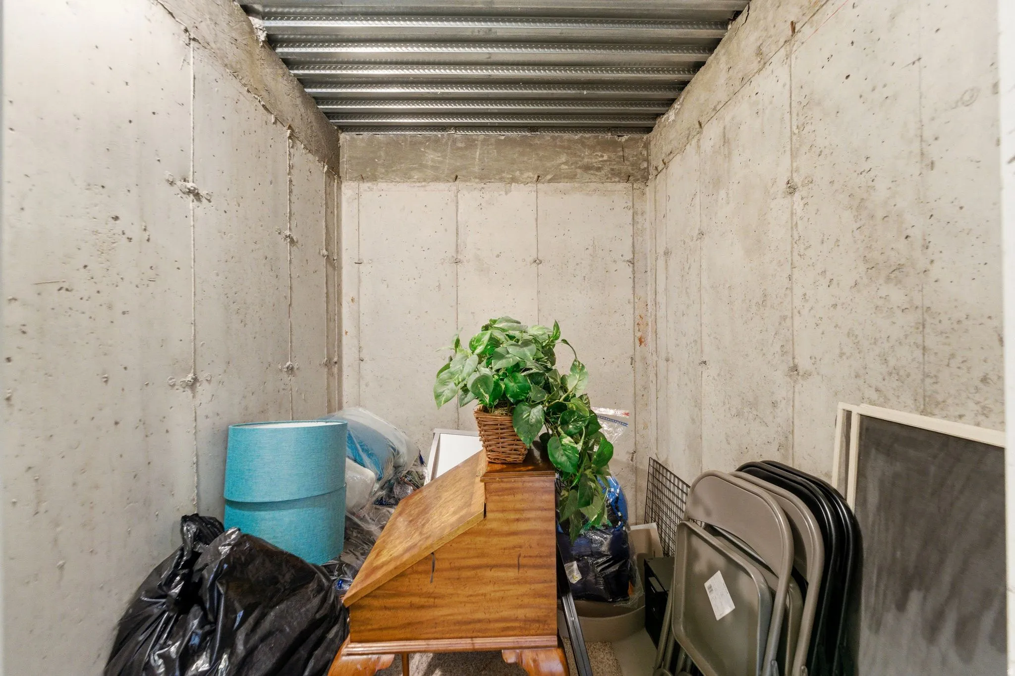 Concrete walled interior space with a corrugated metal ceiling