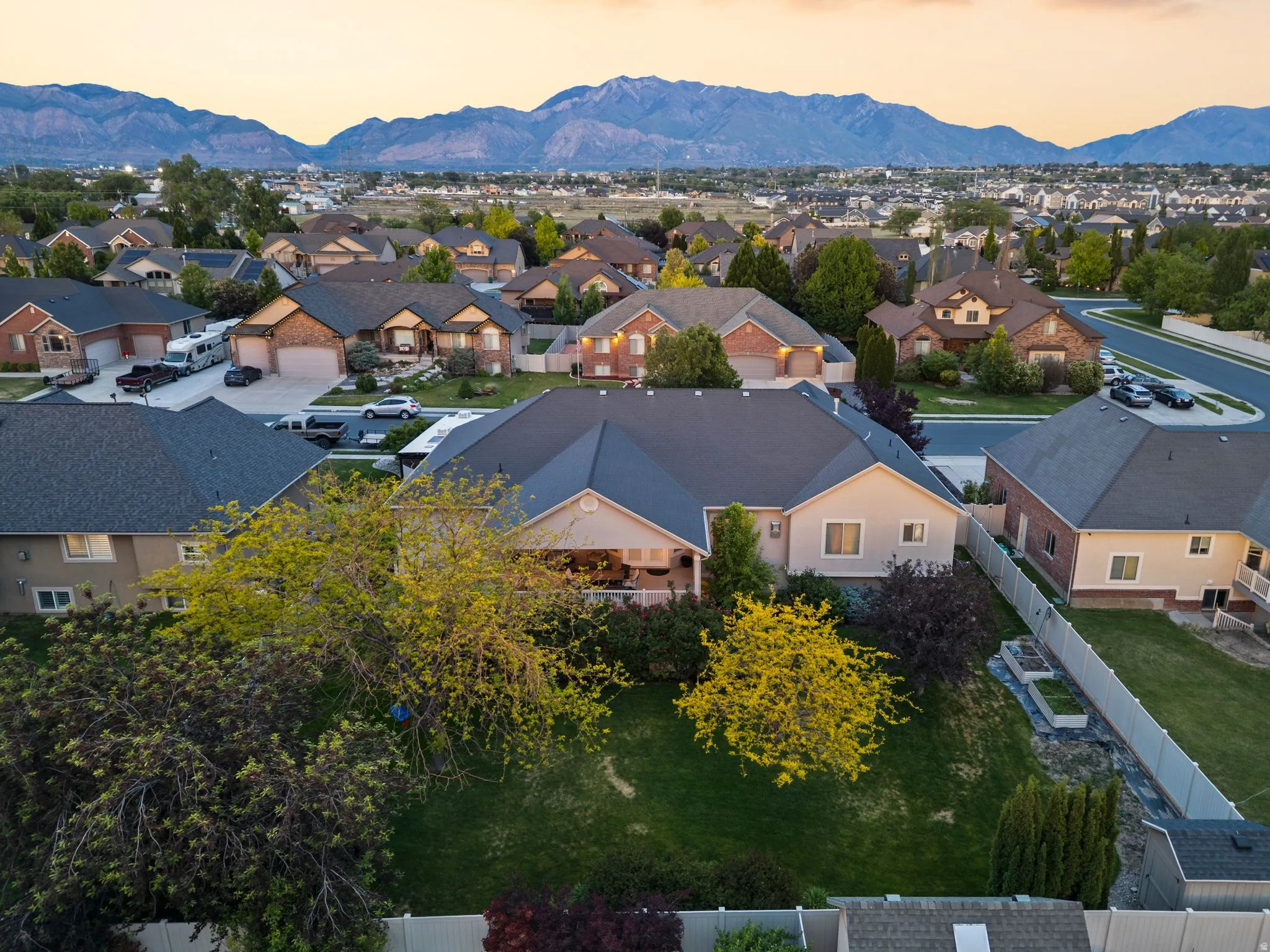 Aerial perspective showcasing a residential neighborhood with mountain scenery