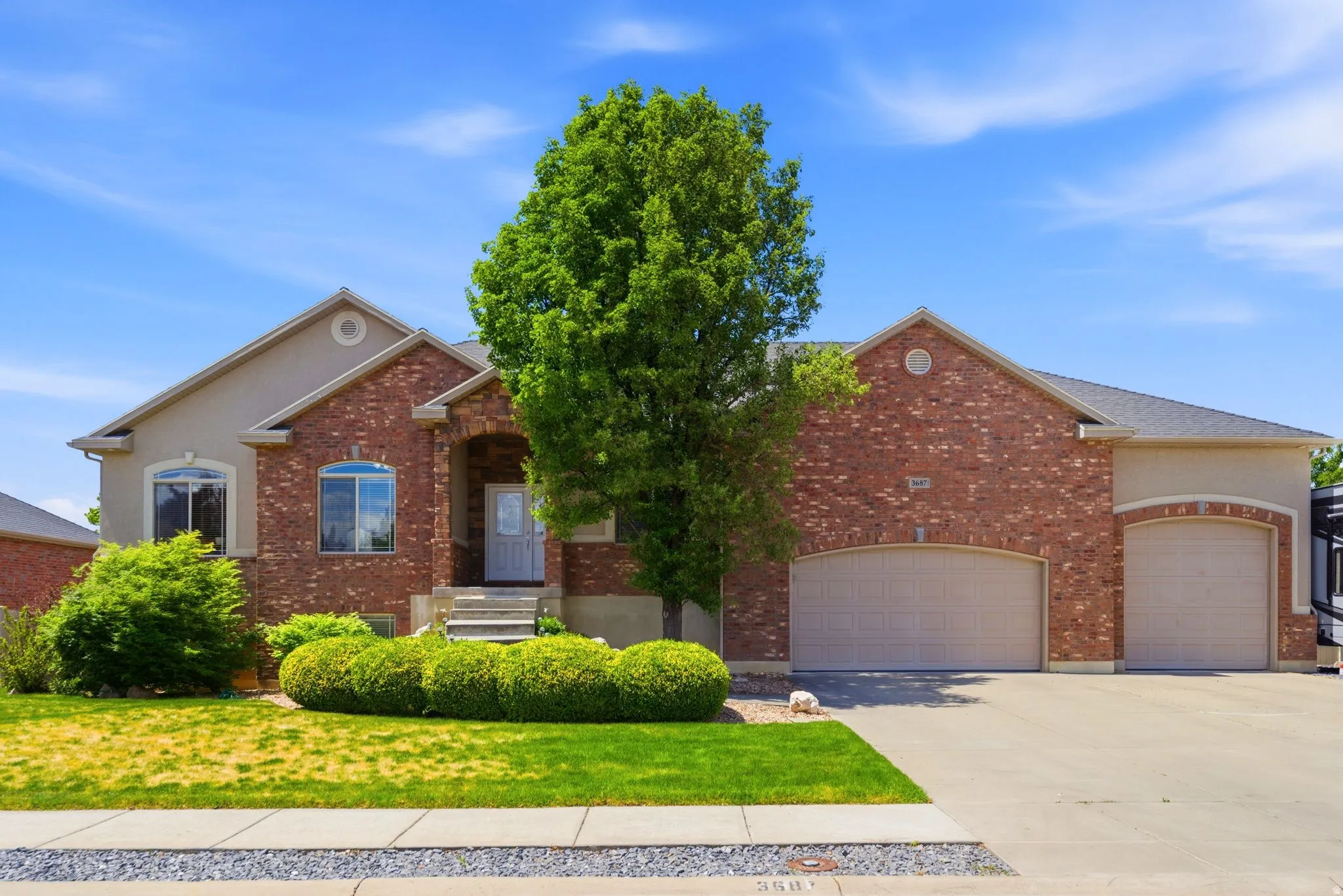 Brick and stucco exterior with multiple gables and varied rooflines