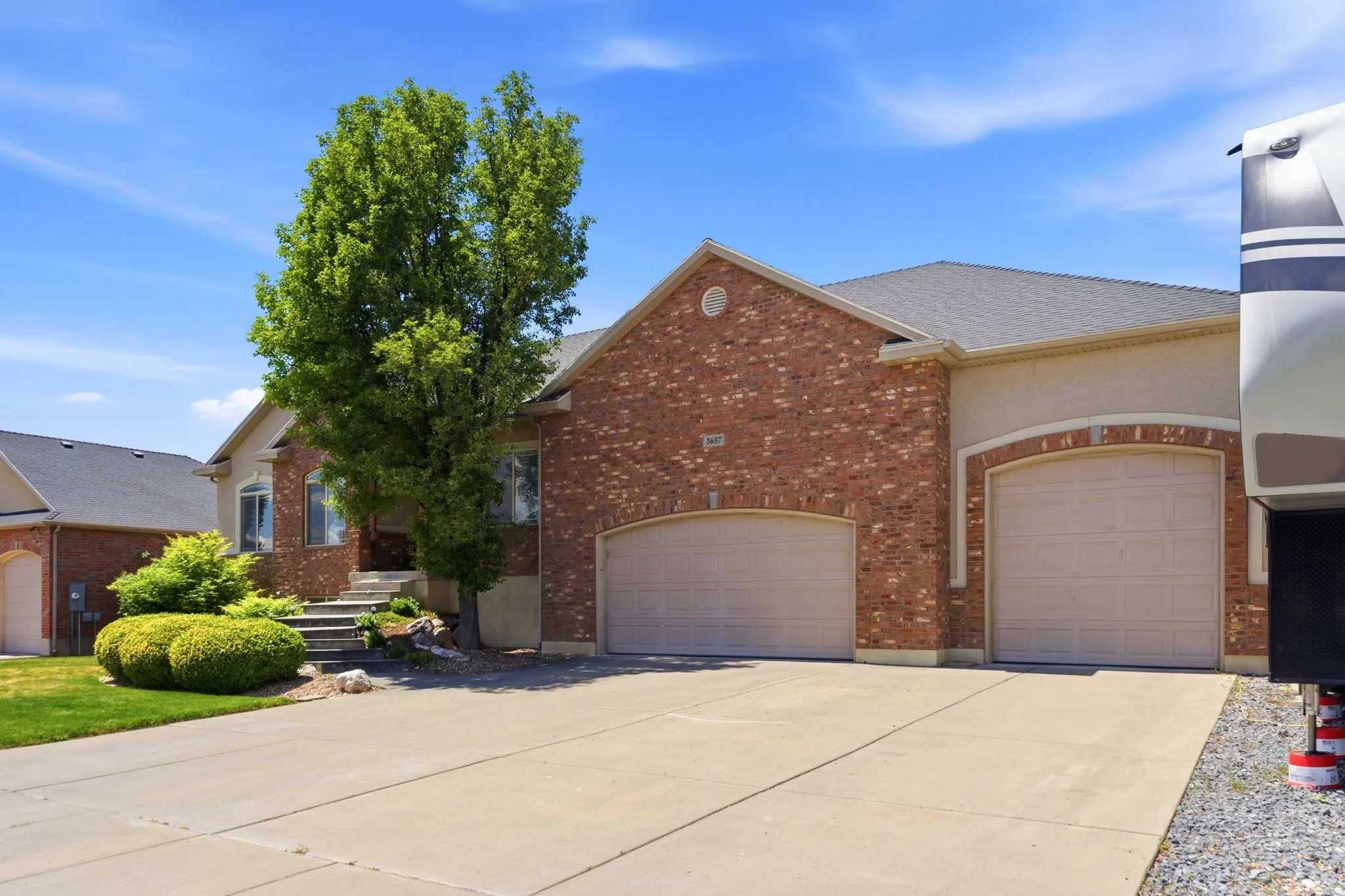 Brick and stucco exterior with multiple garage bays