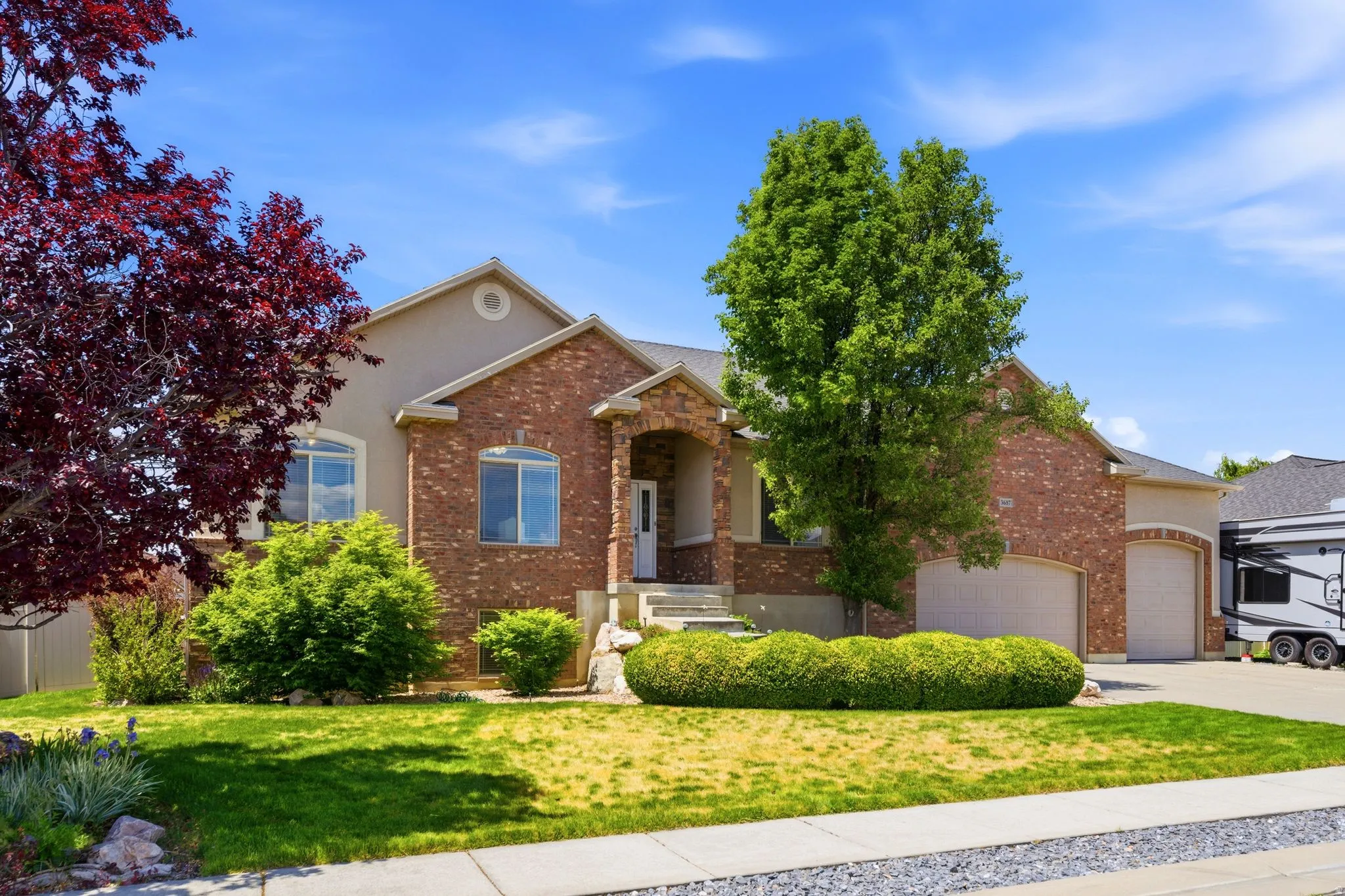 Two-story property featuring brick and stucco exterior