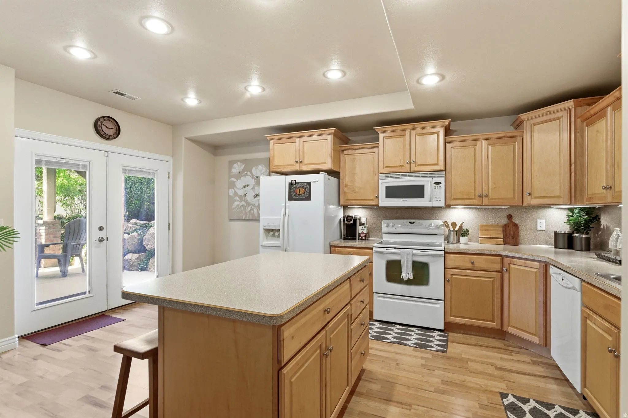 Kitchen featuring light wood cabinetry, recessed lighting, and wood-finish flooring