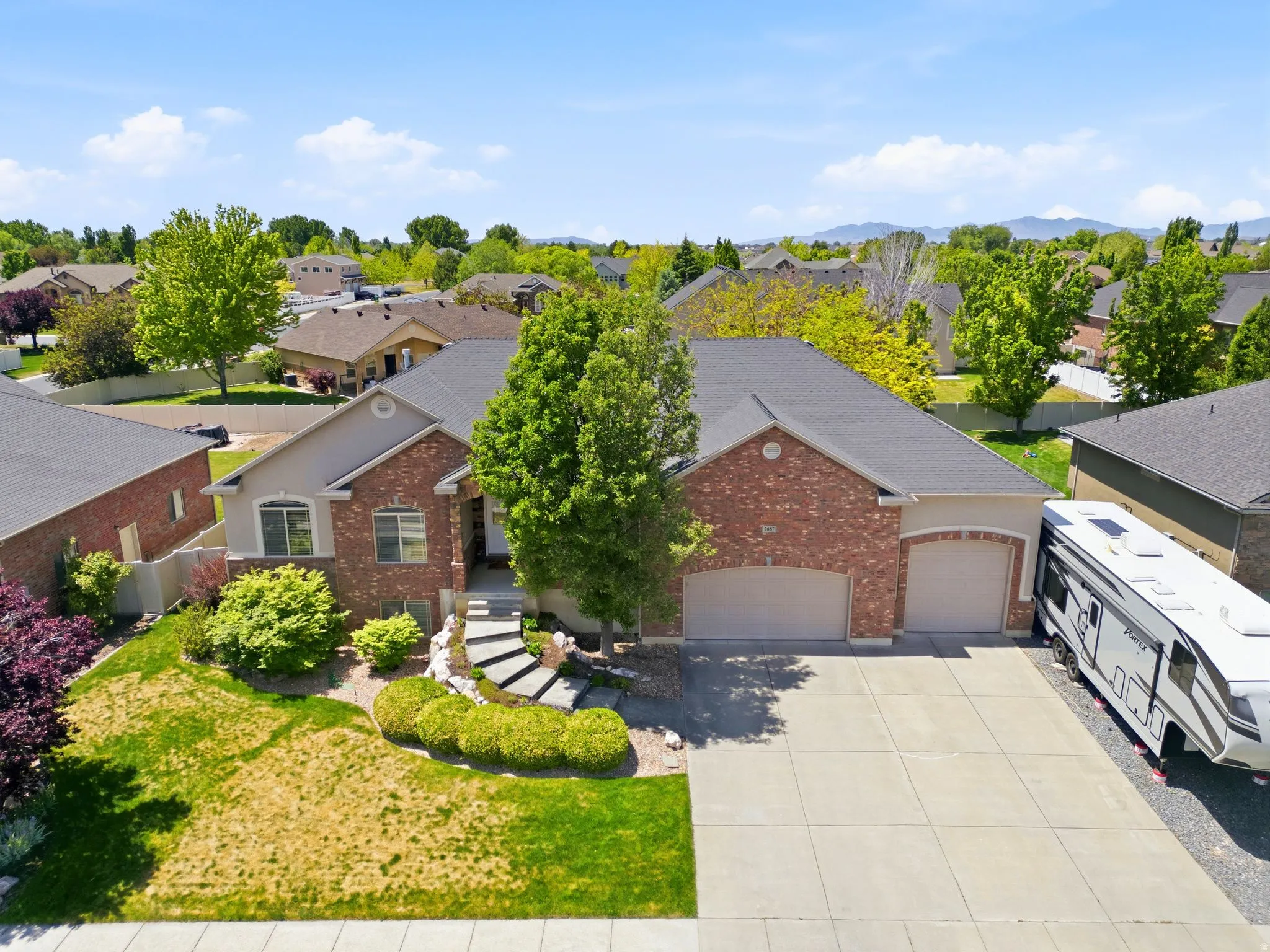 Brick and stucco exterior with an attached two-car garage
