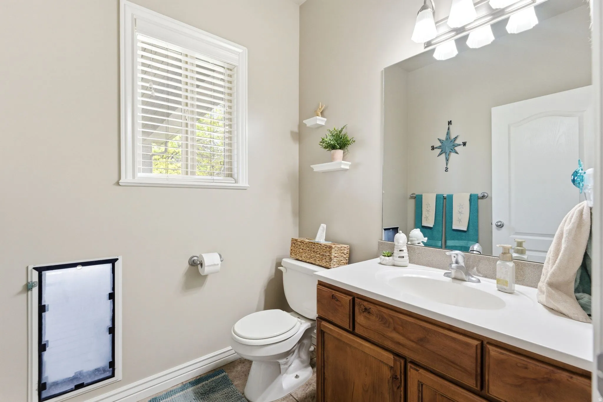 Bathroom featuring a single vanity with wood-finish cabinetry and a white countertop