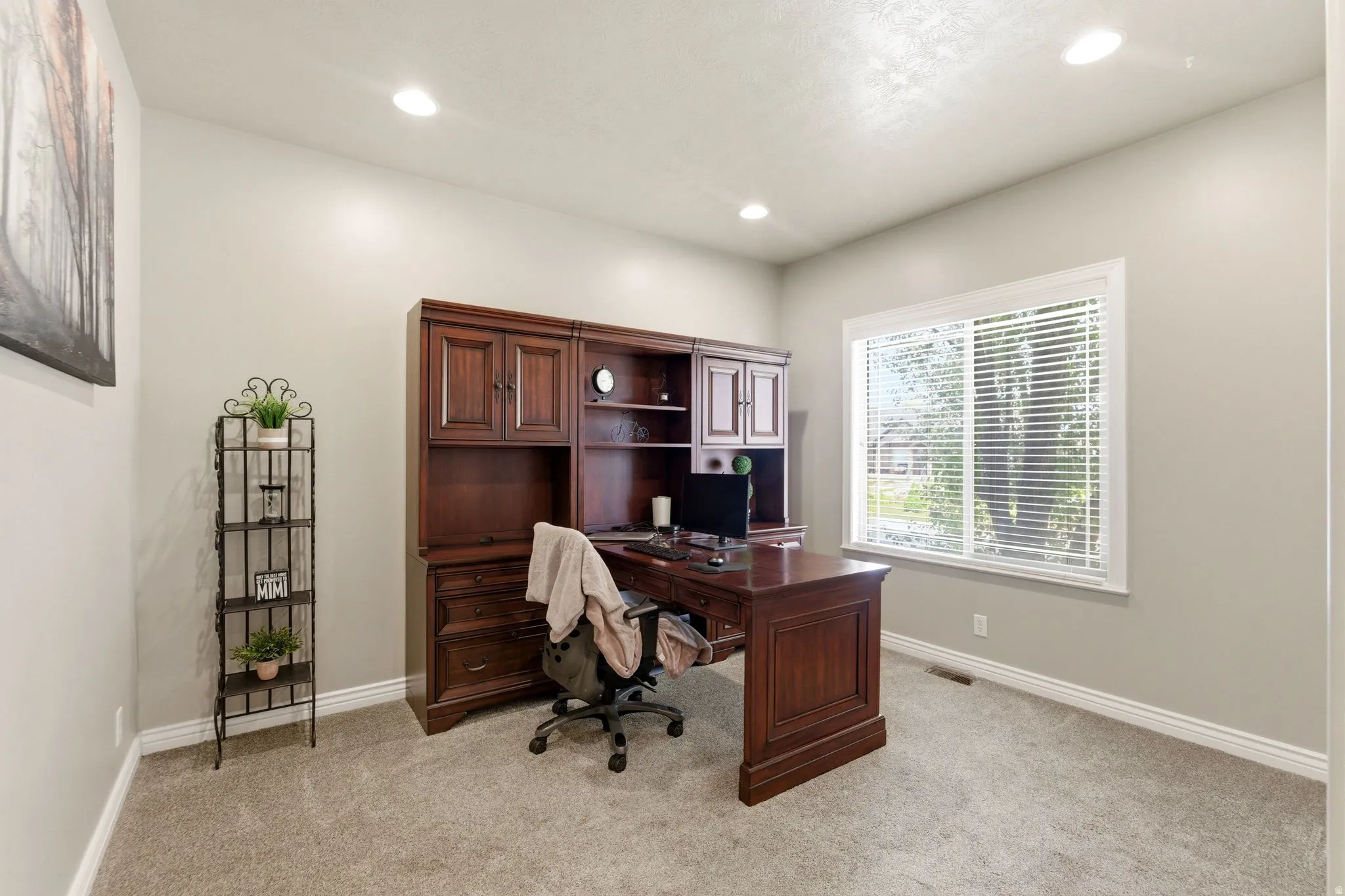 Built-in wood-finish office cabinetry and desk unit with ample storage