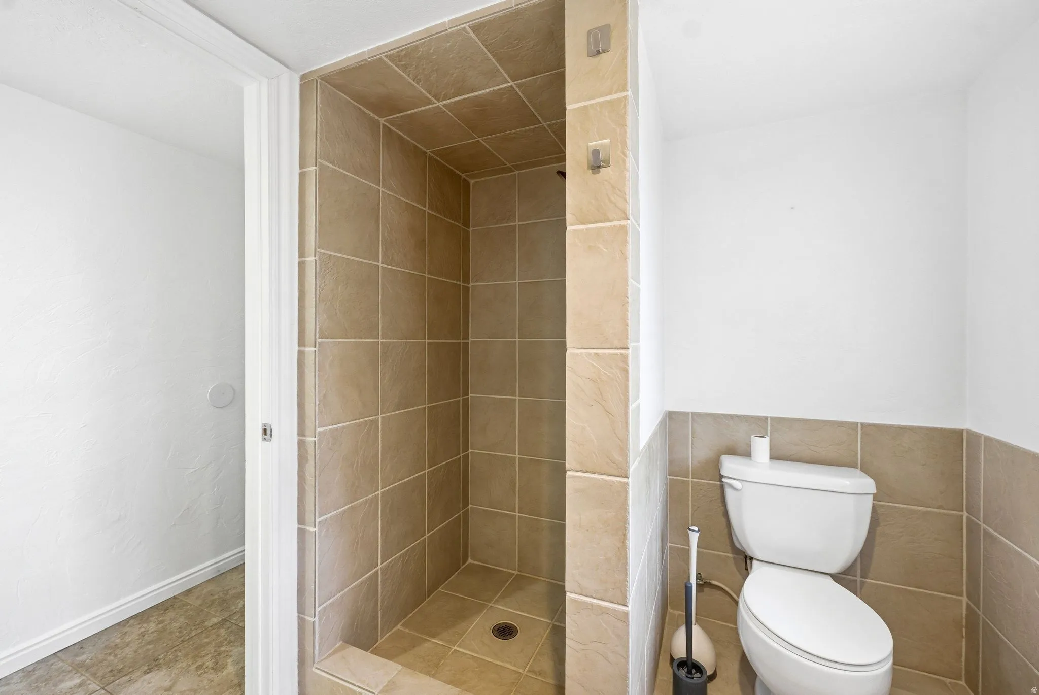 Walk-in shower with full-height tile surround and floor