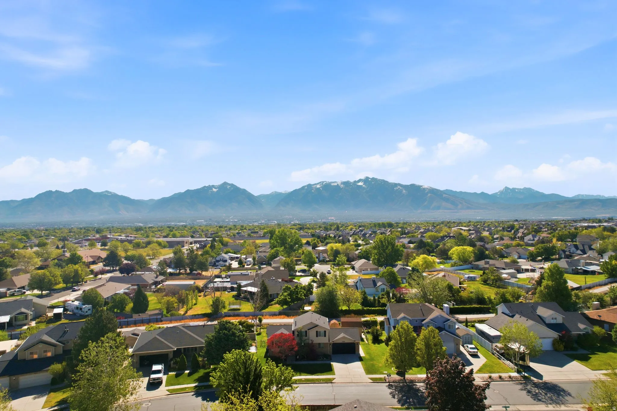 Expansive residential area featuring numerous single-family homes with diverse architectural styles, mature trees, and landscaping