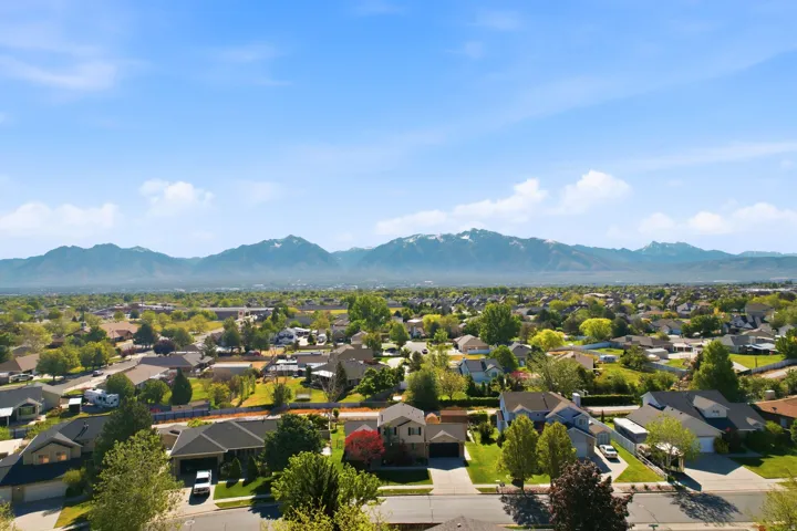 Expansive residential area featuring numerous single-family homes with diverse architectural styles, mature trees, and landscaping