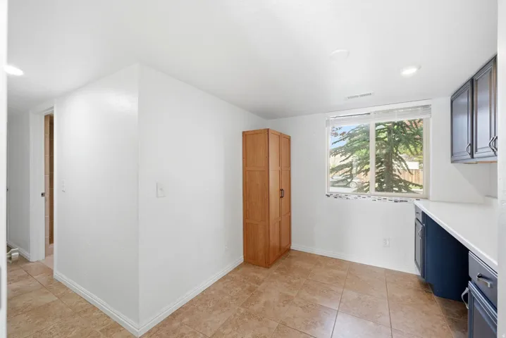White walls with recessed lighting and tile flooring