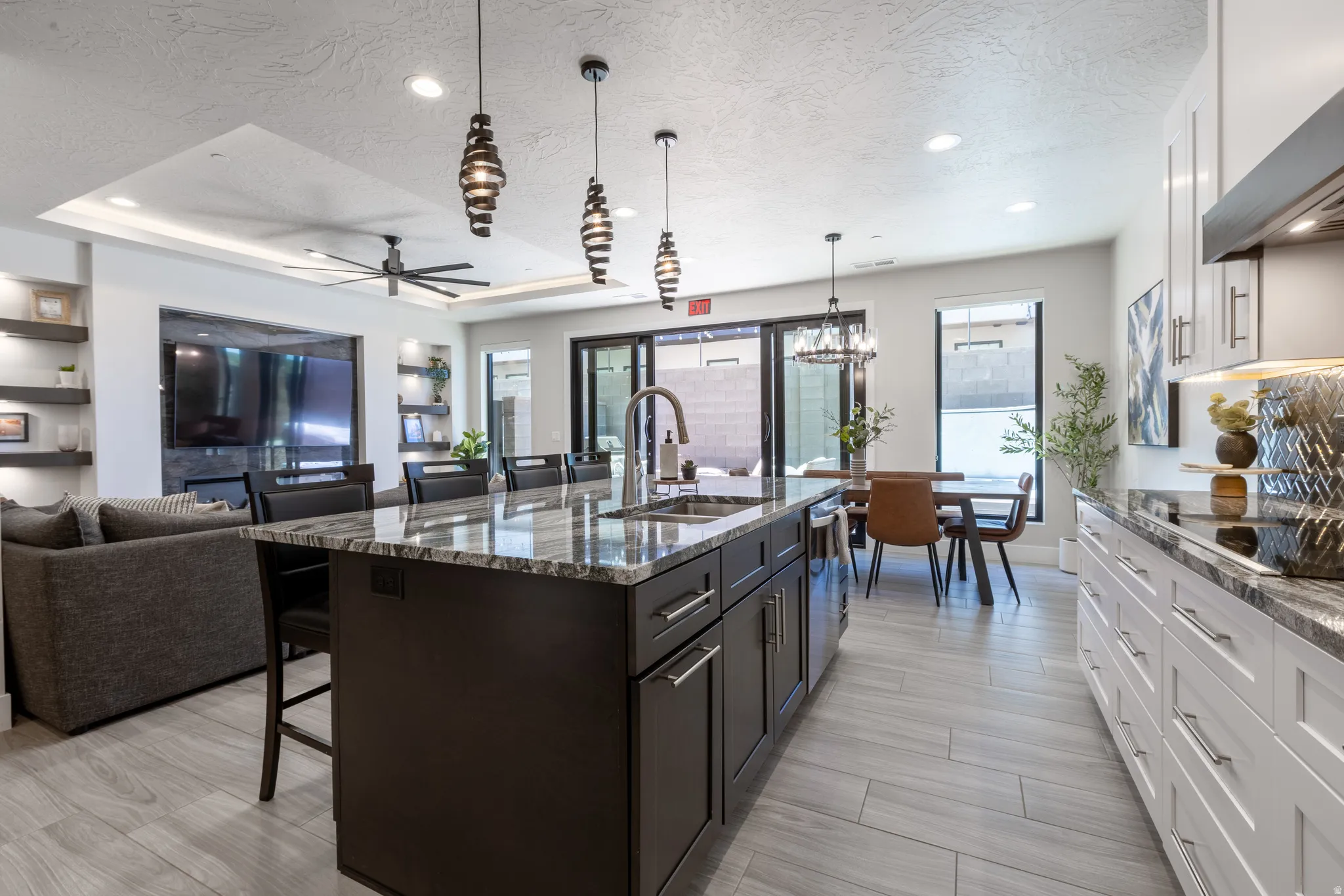 Spacious kitchen island with a dark wood-finish base, integrated sink, and stone countertop