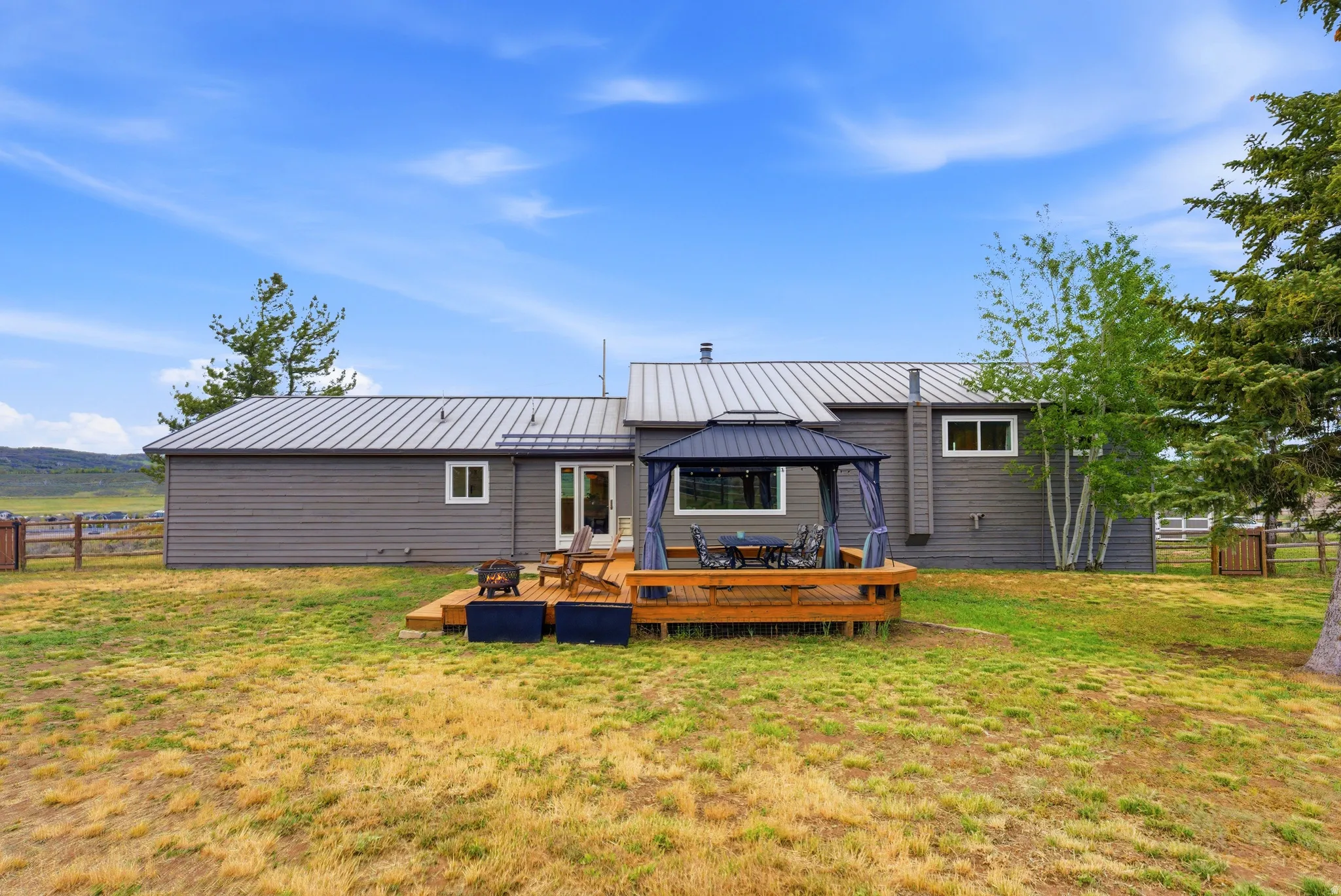 Expansive wooden deck featuring a gazebo, providing a dedicated outdoor living space