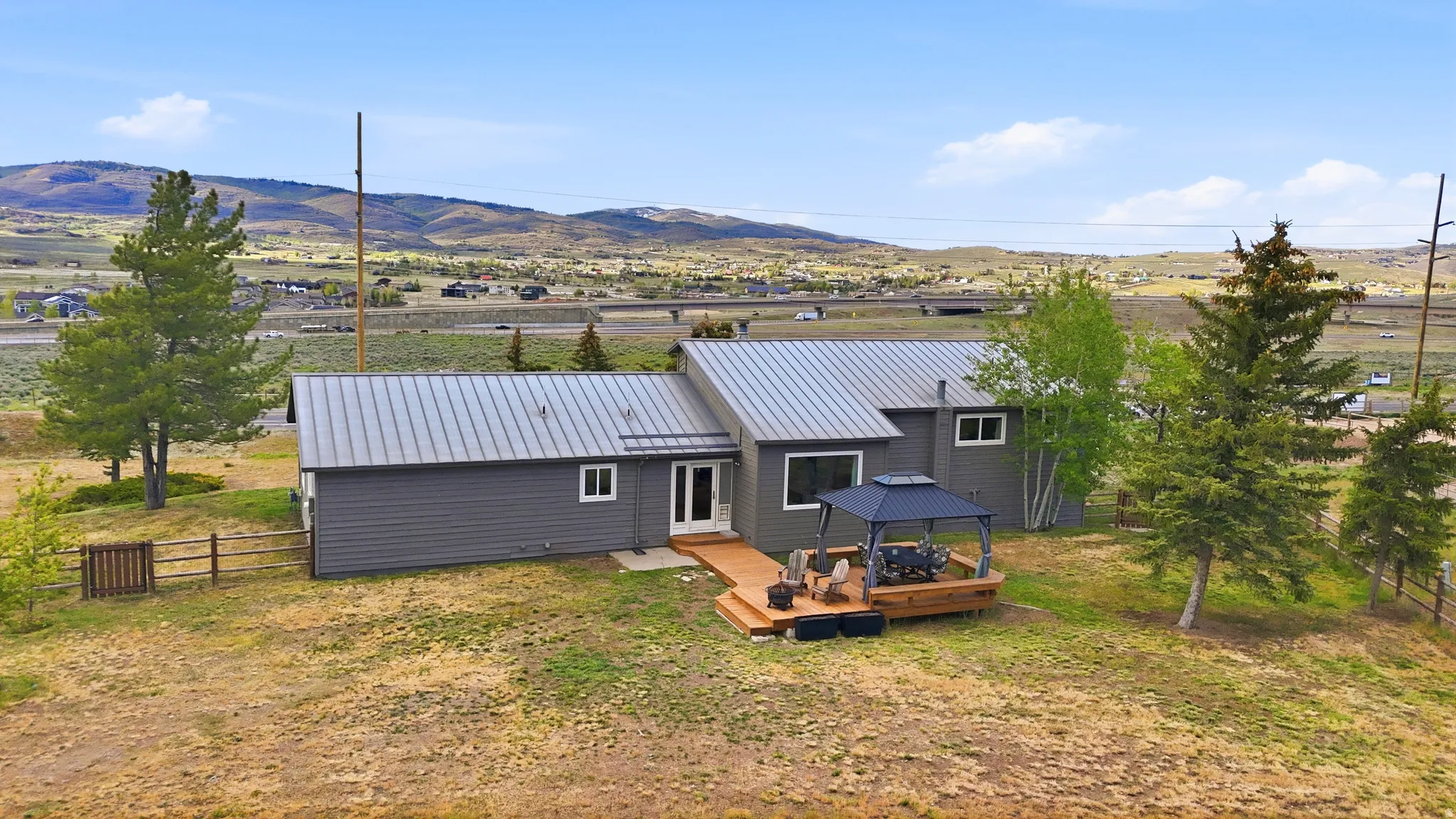 Contemporary gray exterior with a metal roof
