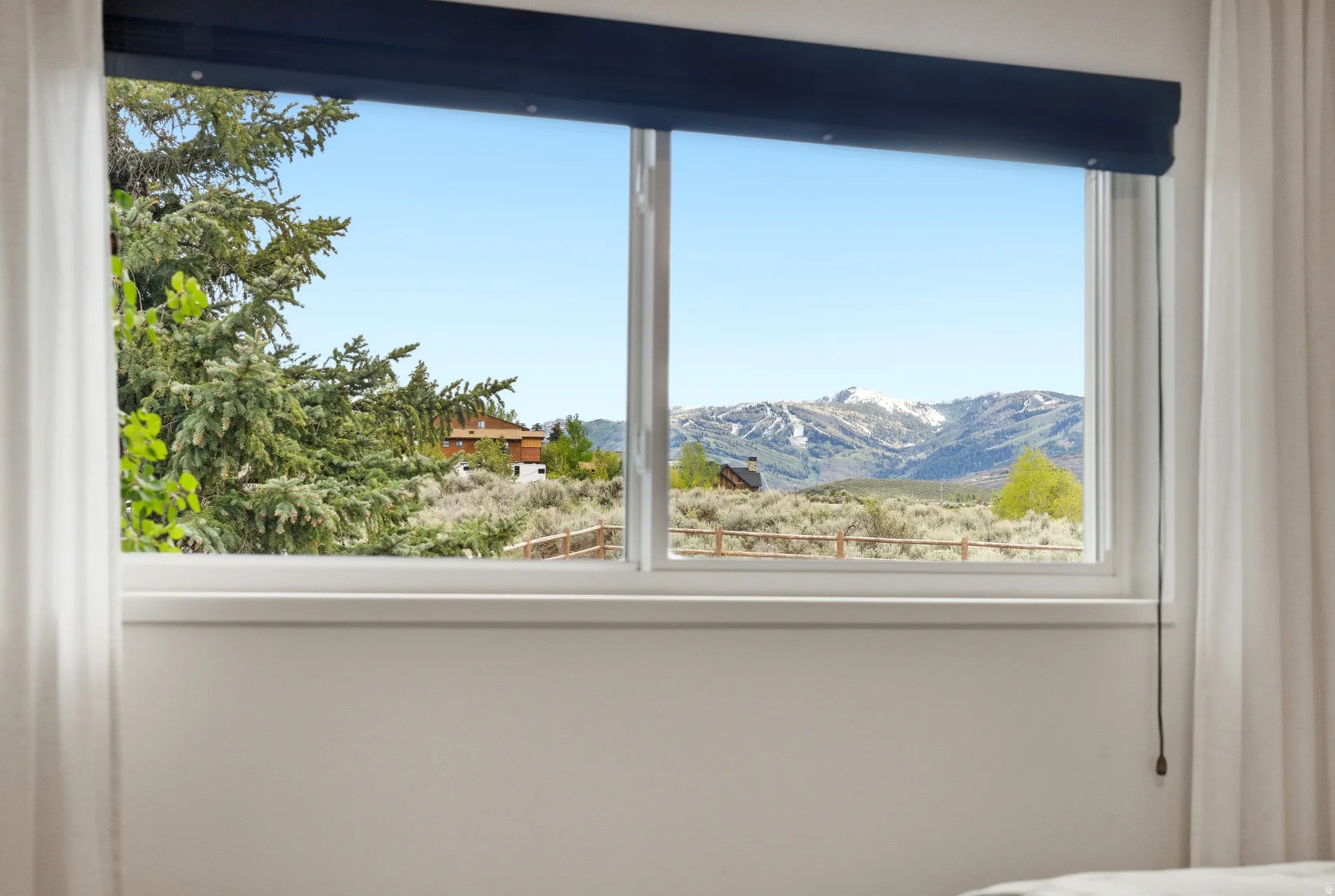 Framed window showcasing a distant mountain range with snow-capped peaks