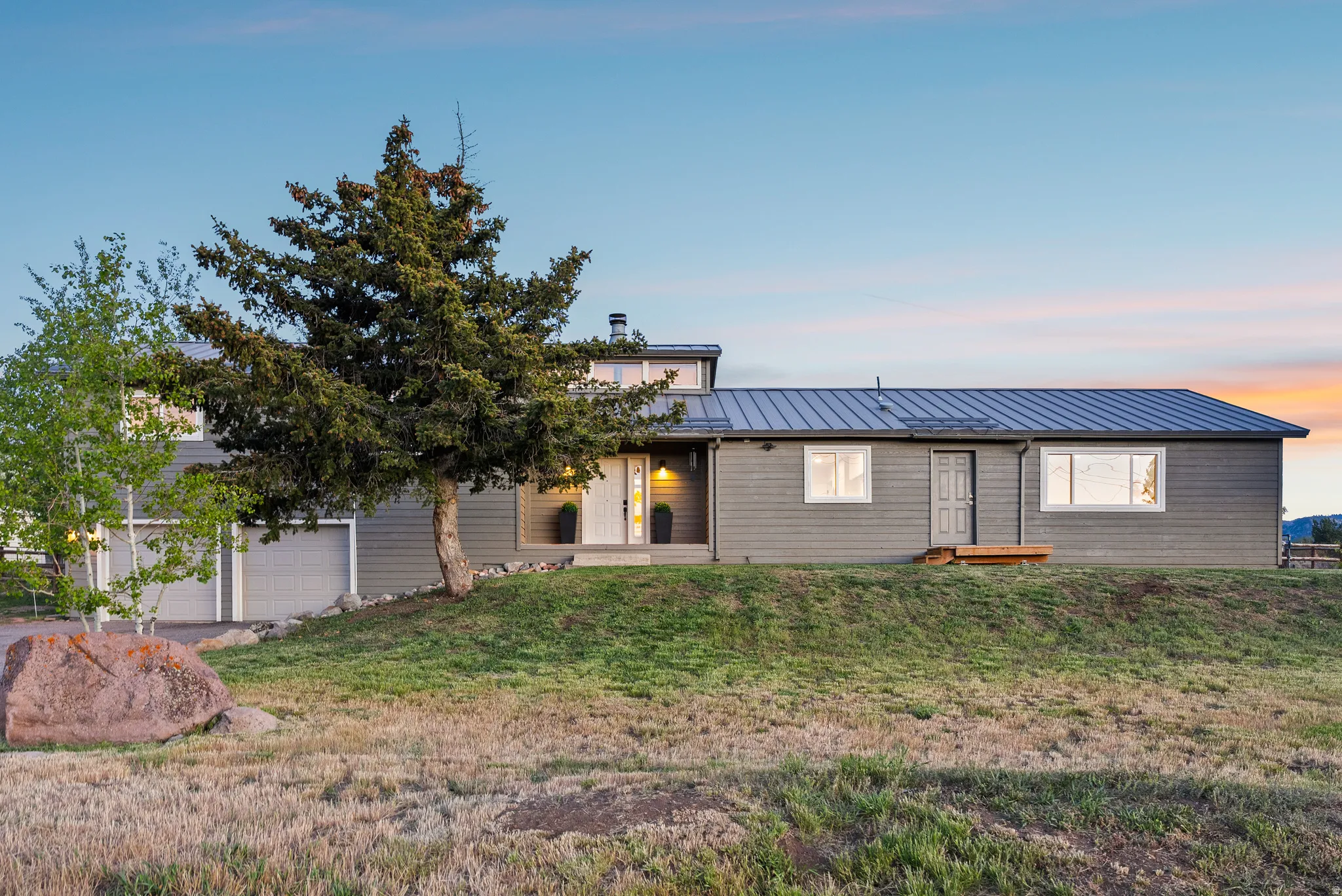 Contemporary residence featuring horizontal siding and a metal roof