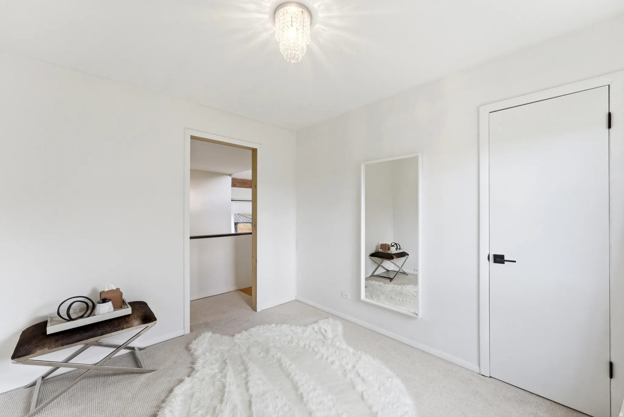 Neutral white walls with a contemporary flush-mount chandelier