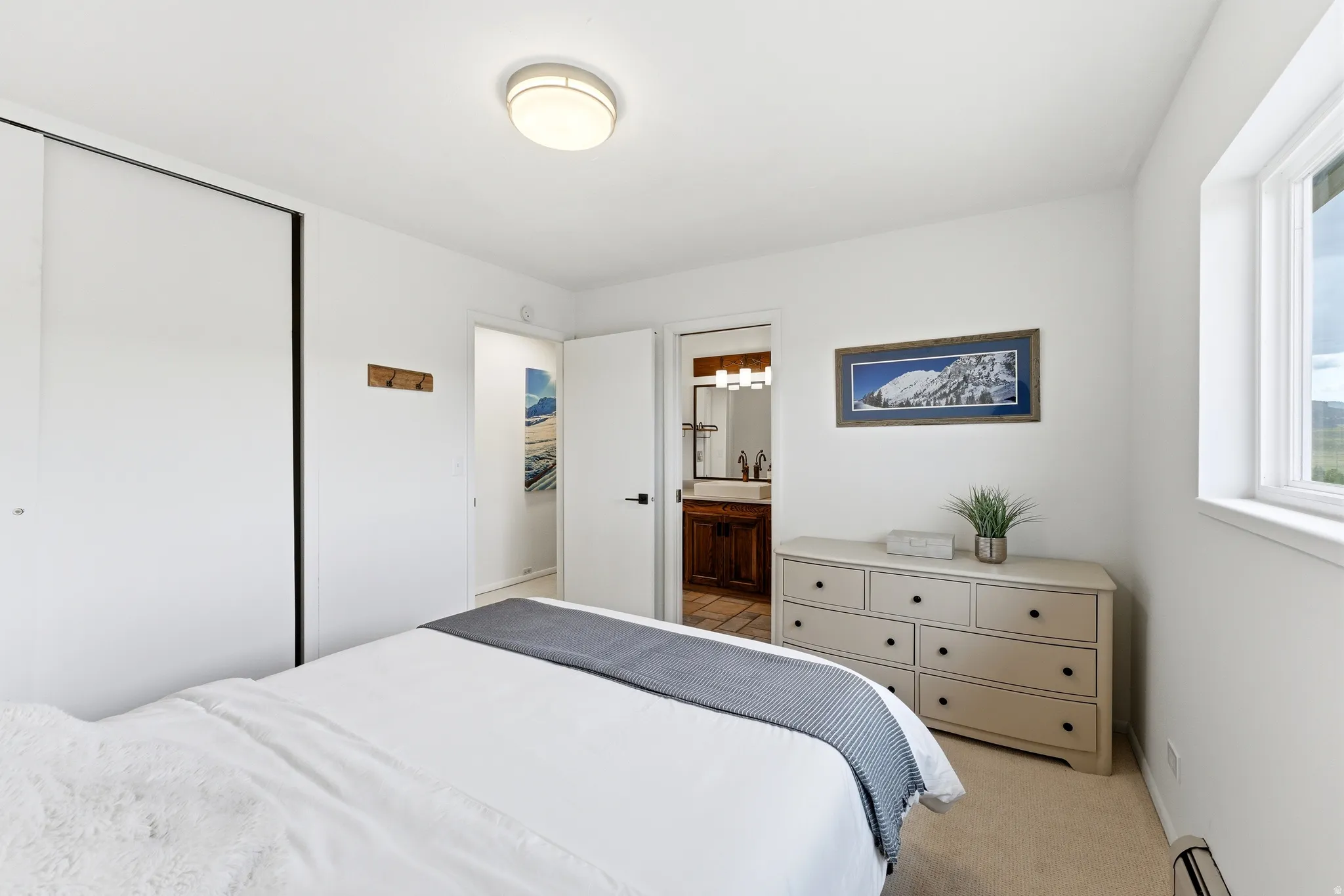 Bedroom featuring a window, neutral carpet flooring, and a flush mount ceiling light fixture