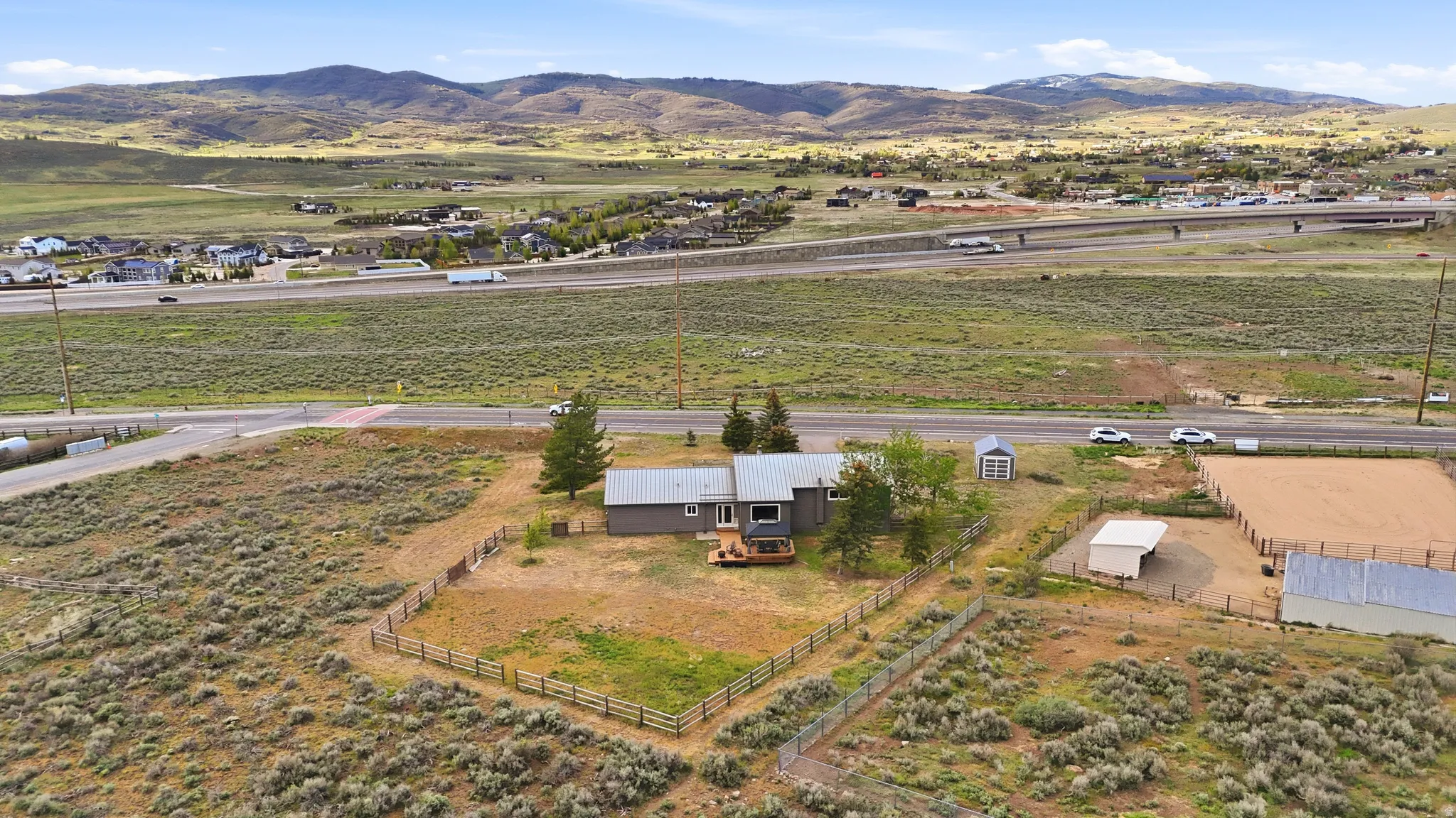 Ranch-style residence featuring a wooden deck, fenced yard area, and a separate shed structure