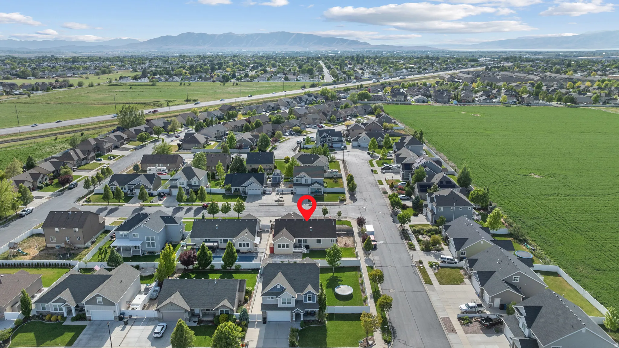Aerial perspective showcasing a residential neighborhood with detached homes, mature landscaping, and paved streets
