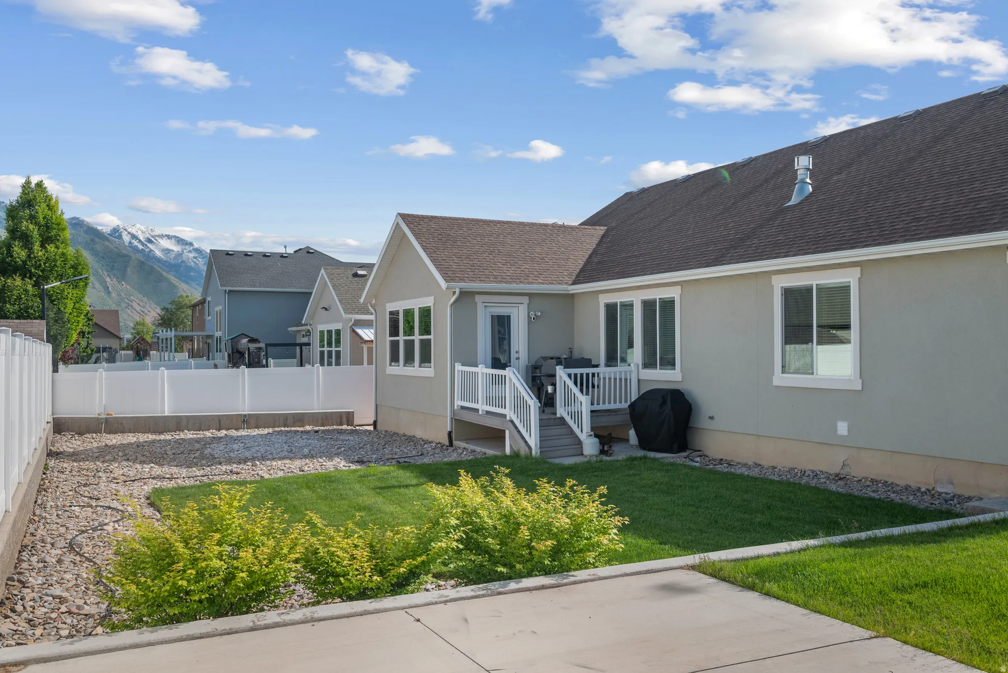 Exterior showcasing stucco siding, a composition shingle roof, and multiple windows