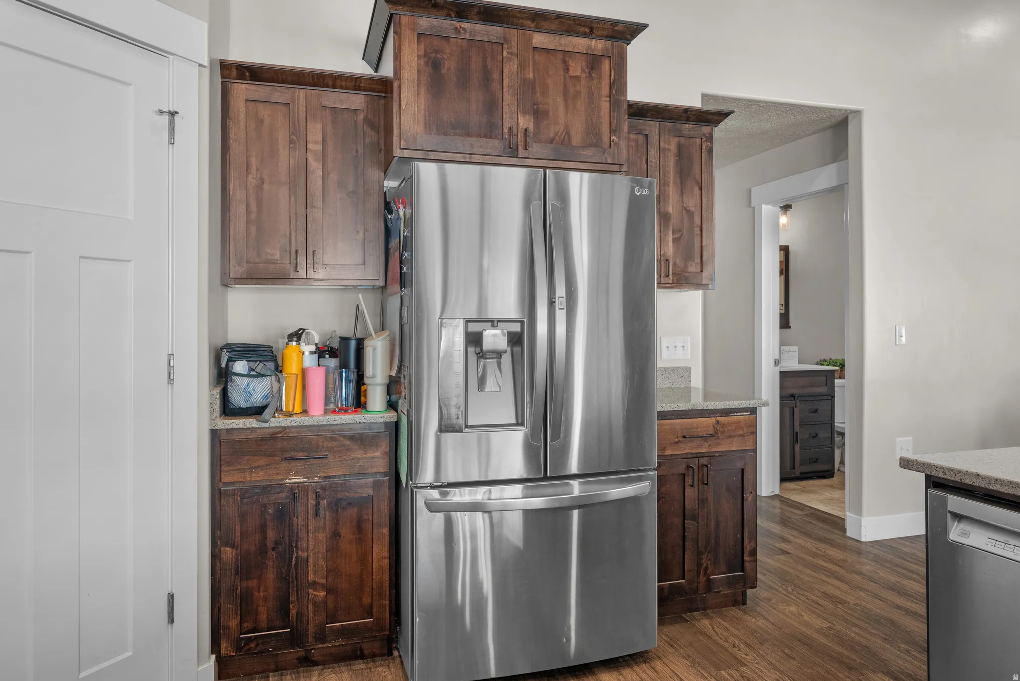 Stainless steel French door refrigerator with an integrated ice and water dispenser