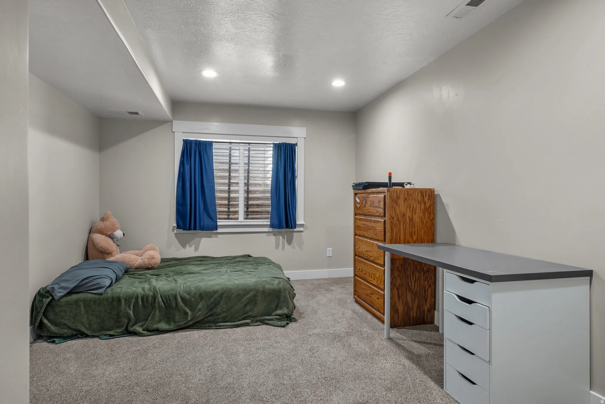 Carpeted room featuring recessed lighting, a window with horizontal blinds, and neutral wall tones