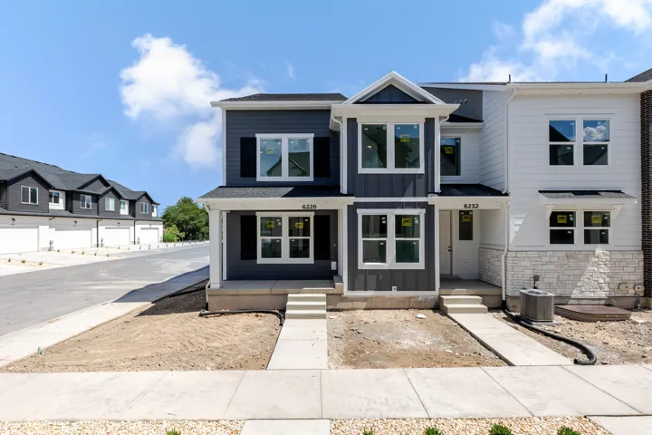 Contemporary exterior with dark siding and white trim accents