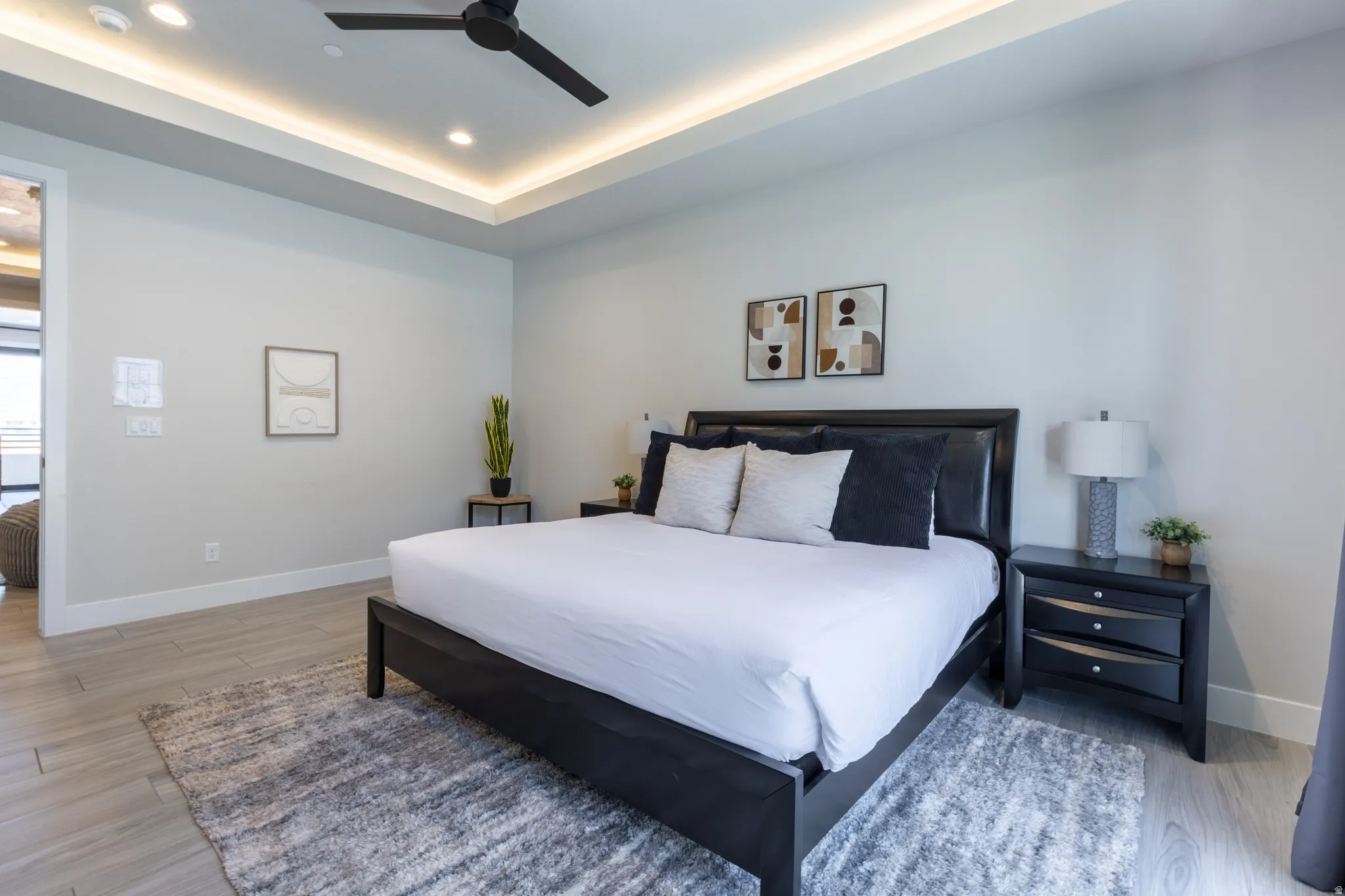 Recessed lighting, ceiling fan, and tray ceiling with ambient lighting