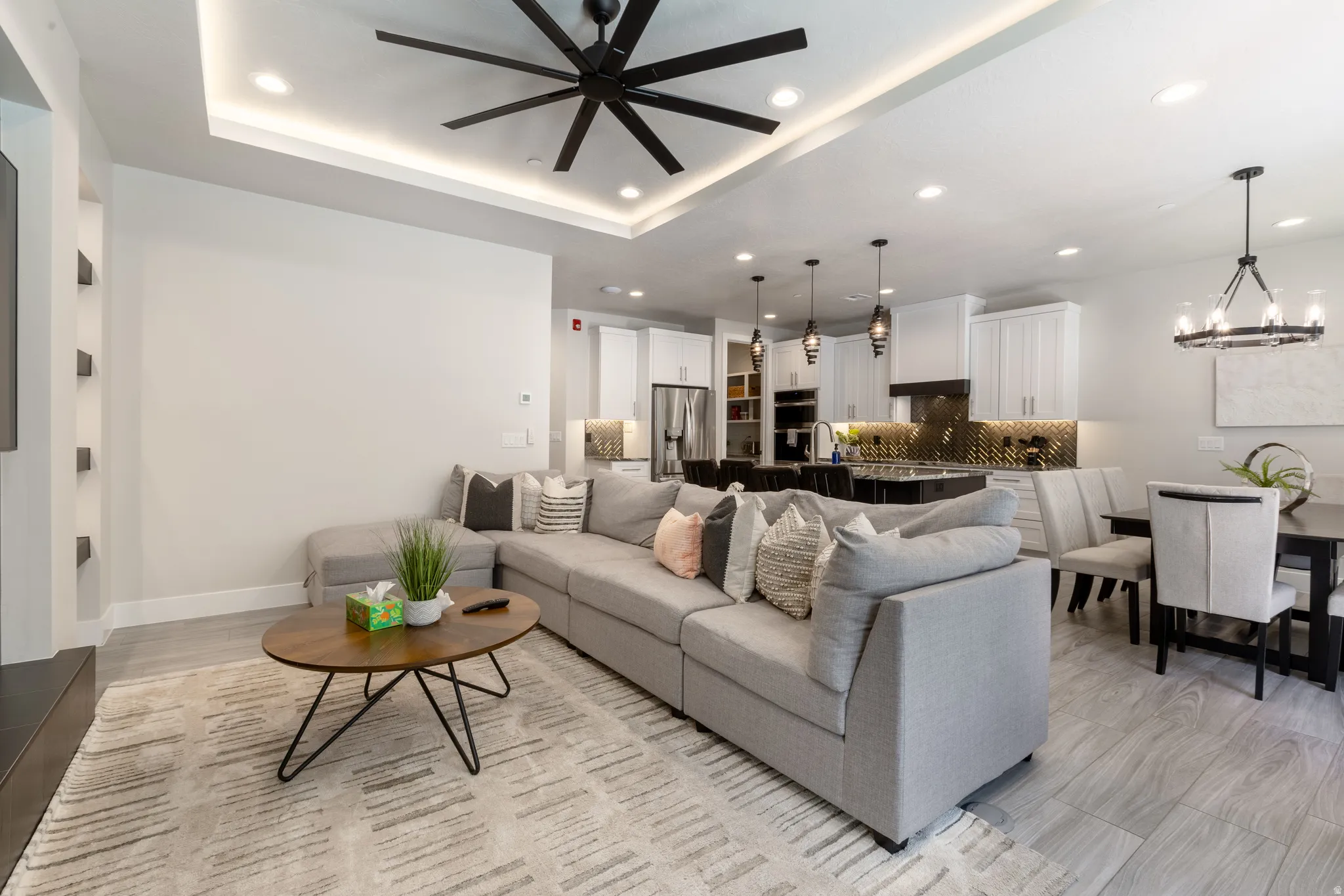 Open-concept living space featuring wood-finish flooring, recessed lighting, and a contemporary ceiling fan