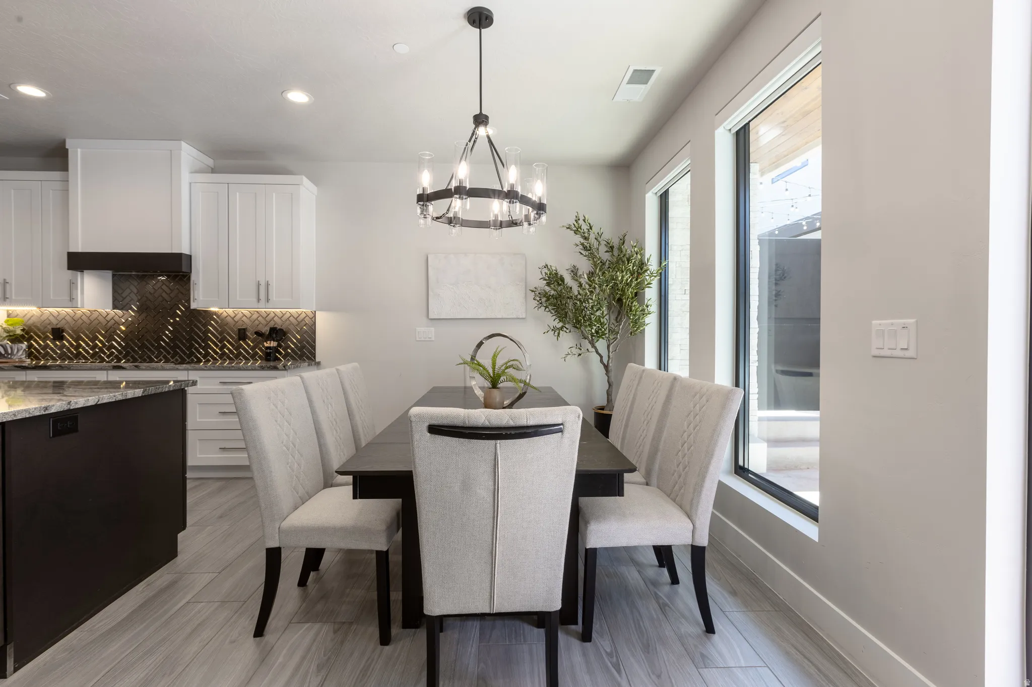 Dining area featuring a dark wood-finish table with upholstered seating